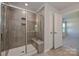 Modern tiled shower with glass enclosure and built-in seat and shelving provides spa-like experience at 1350 31St St, Conover, NC 28613