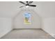 Bright upper bedroom with a high ceiling, plush carpeting, and a window offering a lovely backyard view at 1500 Nectar Way # 32, Kannapolis, NC 28083
