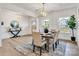 Bright dining area with wood floors, a modern light fixture, and a view of the outdoors at 1500 Nectar Way # 32, Kannapolis, NC 28083