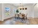 Elegant dining room with wainscoting, wood floors, stylish chandelier, and a view of the outdoors at 1500 Nectar Way # 32, Kannapolis, NC 28083