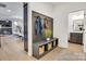 Inviting entryway featuring a built-in bench with coat hooks and storage baskets, flowing into the living and dining areas at 1500 Nectar Way # 32, Kannapolis, NC 28083