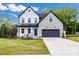 Charming two-story home featuring a stone and siding facade, black accents, and a well-manicured lawn at 1500 Nectar Way # 32, Kannapolis, NC 28083