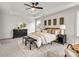 Bright main bedroom featuring a large bed, elegant decor, and a sitting area with stylish black benches at 1500 Nectar Way # 32, Kannapolis, NC 28083