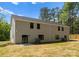 Backyard view featuring a two story home with a spacious yard, patio, and trees at 1604 Breezewood Dr, Charlotte, NC 28262