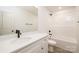 Bright bathroom featuring a modern vanity with sleek fixtures and a shower-tub combo at 1604 Breezewood Dr, Charlotte, NC 28262