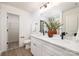 The bathroom showcases a double vanity, white countertops, and an open doorway at 1604 Breezewood Dr, Charlotte, NC 28262