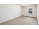 Cozy bedroom with plush carpet and a window providing natural light at 1604 Breezewood Dr, Charlotte, NC 28262