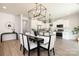 Elegant dining area with views of the kitchen featuring white cabinets and stainless steel appliances at 1604 Breezewood Dr, Charlotte, NC 28262