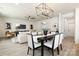 Open dining area with views to the Gathering room and modern lighting fixtures at 1604 Breezewood Dr, Charlotte, NC 28262