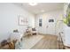 Inviting entryway with bright white walls, light wood flooring, and cozy seating arrangement at 1604 Breezewood Dr, Charlotte, NC 28262