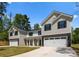 Charming new construction home with a stone base, siding exterior, and attached two-car garage at 1604 Breezewood Dr, Charlotte, NC 28262