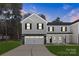 Two story home with a gray and white color scheme, black shutters, and a two car garage at 1604 Breezewood Dr, Charlotte, NC 28262
