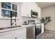 Beautiful kitchen with white cabinets, stainless steel appliances, quartz counters, and a modern black faucet at 1604 Breezewood Dr, Charlotte, NC 28262