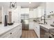 Bright kitchen featuring white cabinets, stainless steel appliances, and modern fixtures at 1604 Breezewood Dr, Charlotte, NC 28262