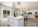 Open floor plan connecting kitchen, dining, and living area with natural light and modern finishes at 1604 Breezewood Dr, Charlotte, NC 28262