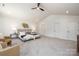 Bright main bedroom featuring a ceiling fan, plush carpet, and ample closet space at 1604 Breezewood Dr, Charlotte, NC 28262