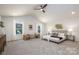 Spacious main bedroom with vaulted ceiling, natural light, and neutral decor at 1604 Breezewood Dr, Charlotte, NC 28262