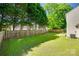 Large, well-maintained backyard with a privacy fence, lush lawn, and mature trees at 1605 Tate Rd # 258, Rock Hill, SC 29732