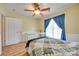 Comfortable bedroom with wood flooring, a ceiling fan, and a window providing ample natural light at 1605 Tate Rd # 258, Rock Hill, SC 29732