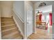Hallway with staircase leading to an upstairs floor, next to an inviting dining room with natural light at 1605 Tate Rd # 258, Rock Hill, SC 29732