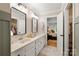 Bright bathroom featuring double sinks, framed mirrors, and an open doorway to the main bedroom and walk in closet at 1631 Amanda Ln, Rock Hill, SC 29730
