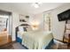 Cozy bedroom featuring hardwood floors, a large window, and a queen-sized bed with decorative pillows at 1631 Amanda Ln, Rock Hill, SC 29730