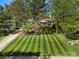 Charming home with a well-manicured front lawn, mature trees, and a welcoming front porch at 1631 Amanda Ln, Rock Hill, SC 29730