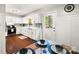 Eat in kitchen with white cabinets, modern backsplash, and dark stained wood flooring at 1631 Amanda Ln, Rock Hill, SC 29730