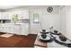 Eat in kitchen with white cabinets, modern backsplash, and dark stained wood flooring at 1631 Amanda Ln, Rock Hill, SC 29730