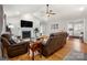 Spacious living room with hardwood floors, fireplace, and comfortable brown reclining sofas at 1631 Amanda Ln, Rock Hill, SC 29730