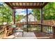 Covered porch with a wood ceiling, outdoor furniture, a wooden railing, and a view of the backyard at 1631 Amanda Ln, Rock Hill, SC 29730