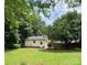 A detached garage sits in the backyard of a home with large trees at 165 Graceland Pl, Salisbury, NC 28146