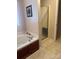 Well-lit bathroom features a soaking tub and a glass-enclosed shower for spa-like relaxation at 165 Graceland Pl, Salisbury, NC 28146