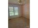 Bright bedroom featuring neutral carpet, a window with tree views, and a ceiling fan at 165 Graceland Pl, Salisbury, NC 28146