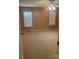 Inviting bedroom featuring neutral carpet, two windows for natural light, and a ceiling fan at 165 Graceland Pl, Salisbury, NC 28146