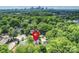 Stunning aerial shot of a house nestled among lush trees with a city skyline in the background at 1804 Thomas Ave, Charlotte, NC 28205