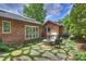 Backyard showing the outdoor kitchen, patio, fire pit and lush landscaping at 1804 Thomas Ave, Charlotte, NC 28205