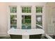 Bathroom close up of tub overlooking the pool in a serene backyard at 1804 Thomas Ave, Charlotte, NC 28205