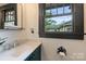 Stylish bathroom with custom vanity, modern fixtures, and ample natural light at 1804 Thomas Ave, Charlotte, NC 28205