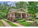 Charming brick home with a landscaped yard and inviting front porch at 1804 Thomas Ave, Charlotte, NC 28205