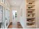 Hallway with hardwood floors, glass paneled doors and built-in shelving at 1804 Thomas Ave, Charlotte, NC 28205