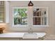 Bright kitchen sink with a view of the backyard pool and pergola at 1804 Thomas Ave, Charlotte, NC 28205