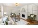 Inviting living room with a white painted brick fireplace and hardwood floors at 1804 Thomas Ave, Charlotte, NC 28205