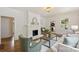 Open living room featuring a painted brick fireplace and hardwood floors at 1804 Thomas Ave, Charlotte, NC 28205