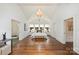 Spacious primary bedroom with vaulted ceiling, chandelier, hardwood floors, and ample natural light at 1804 Thomas Ave, Charlotte, NC 28205