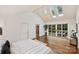 Primary bedroom featuring vaulted ceiling, chandelier, hardwood floors, and French doors at 1804 Thomas Ave, Charlotte, NC 28205