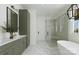 Modern bathroom featuring stylish vanity with olive green cabinets, a glass-enclosed shower, and a soaking tub at 1807 Kennesaw Dr, Charlotte, NC 28216