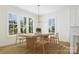 Bright dining room with large windows, a stylish chandelier, and a wooden dining table set at 1807 Kennesaw Dr, Charlotte, NC 28216