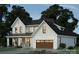 Stunning exterior elevation of a two-story home featuring a black roof and a two-car garage at 1807 Kennesaw Dr, Charlotte, NC 28216