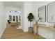 Elegant foyer with wood flooring, a staircase, and stylish decor creating a welcoming ambiance at 1807 Kennesaw Dr, Charlotte, NC 28216